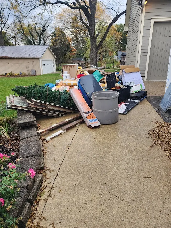 Dumpster being loaded with debris for 12 Yard Dumpster Rental in Oakland Park
